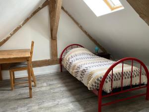 a bedroom with a bed and a desk in a attic at ZenViewStudios in Saint-Agil