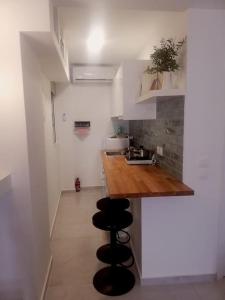 a small kitchen with a counter and a sink at BRIO luxurious urban stay in Heraklio,WiFi,ΑC in Heraklio