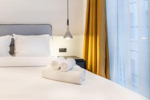 Ein Bett oder Betten in einem Zimmer der Unterkunft PAREA Athens