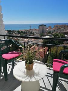 a table with a potted plant on a balcony at BRISAMAR Apartamento con aire acondicionado in Torremolinos