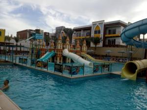 a pool at a resort with a water slide at A two-room chalet in the village of Lale Land, Mirage Bay, Ecopark in Hurghada