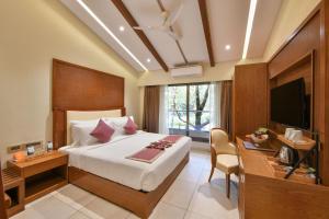 a bedroom with a bed and a desk and a television at Arova Woods Zinc Journey by The Fern, Lonavala in Lonavala +22 photos
