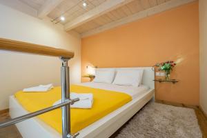 a bedroom with a bed with a yellow blanket at Boutique Hotel Fortino in Chania