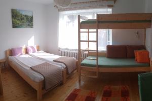 a bedroom with two bunk beds and a chair at Królówka in Maków Podhalański