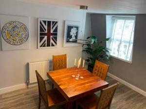 a dining room with a wooden table and chairs at Plymouth city centre apartment near Theatre Royal in Plymouth +9 photos