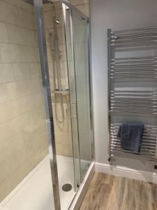 a shower with a glass door in a bathroom at Plymouth city centre apartment near Theatre Royal in Plymouth
