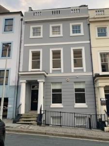 a large white building on the corner of a street at Plymouth city centre apartment near Theatre Royal in Plymouth