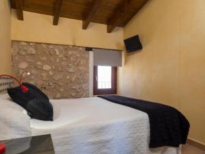 a bedroom with a bed with a black bag on it at Casa del Sol in Búger +22 photos