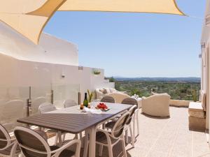 a dining room with a table and chairs on a balcony at Casa del Sol in Búger