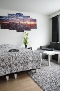 a bedroom with a bed and a living room at Railway&bus station studio in Oulu