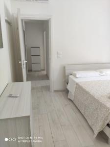 um quarto branco com uma cama e uma mesa em Francavilla 100 passi dal mare em Francavilla al Mare