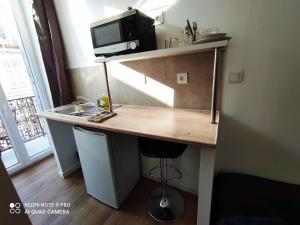 a kitchen with a counter with a microwave and a sink at Hostel Lyonnais in Nice