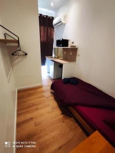 a bedroom with a bed and a desk in a room at Hostel Lyonnais in Nice