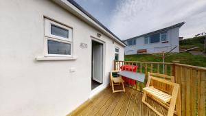 a deck with chairs and a table on a house at E17 Glenvale, Riviere Towans in Hayle