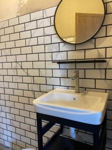 a white sink in a bathroom with a mirror at Z&Z Budget Room in Kampung Kuala Besut