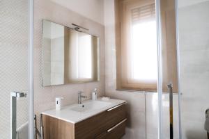 a bathroom with a sink and a mirror and a shower at A CASA DI FIBI in Salerno