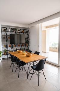 a dining room with a wooden table and chairs at A CASA DI FIBI in Salerno