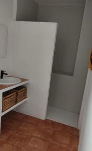 a bathroom with a sink and a white wall at Casa Lucas in Grazalema