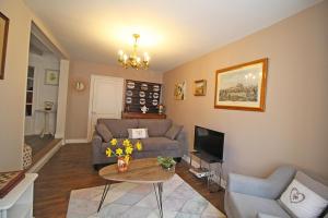 a living room with a couch and a table at La maison de marie in Saint-Germain-les-Belles