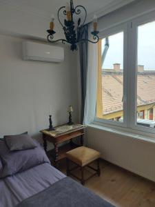 a bedroom with a bed and a window and a table at Casa Del Hodos in Budapest