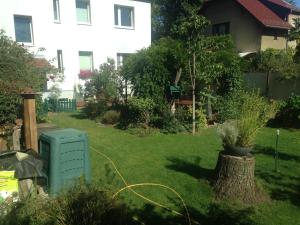 a yard with a green utility box in the grass at Ferienwohnung Heil - Königs Wusterhausen in Königs Wusterhausen