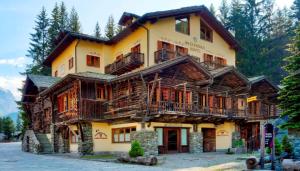 a large wooden building with balconies on it at Hotel Breithorn in Champoluc