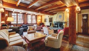 a living room filled with furniture and a fireplace at Hotel Breithorn in Champoluc