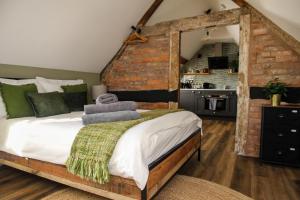 a bedroom with a bed with a brick wall at no 12 - Stunning Self Check-in Apartments in Worcester Centre in Worcester