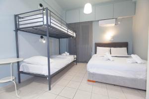 a bedroom with two beds and a bunk bed at Athens City Themis 5 in Athens