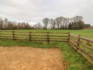 a wooden fence in front of a field at Chestnut 5 in Broadway
