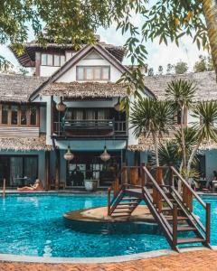a resort with a swimming pool and a house at Villa Samadhi by Samadhi - Adults Only in Kuala Lumpur