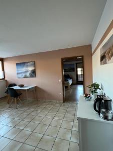 a kitchen and dining room with a table and a counter at Ferienwohnung Schneider mit Balkon in Bad Laasphe