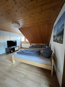 a bedroom with a bed with a wooden ceiling at Ferienwohnung Schneider mit Balkon in Bad Laasphe