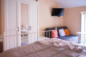 a bedroom with a bed and a chair at Agriturismo Casa Scola in Gragnano