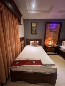 a bedroom with a large bed in a room at Beat Hotel Siem Reap in Siem Reap