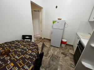 a kitchen with a refrigerator and a bed in a room at Astra House in Paralio Astros