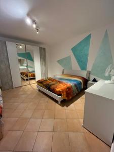 a bedroom with a bed with a painting on the wall at Un nido sul lago in Ranzanico