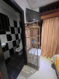 uma casa de banho com WC e uma gaiola num quarto em Beat Hotel Siem Reap em Siem Reap