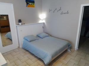 a small bed in a room with a mirror at Charmant studio centre bourg in Woincourt