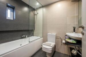a bathroom with a tub and a toilet and a sink at Boutique Hotel Fortino in Chania