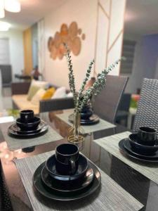 a table with black cups and plates on top of it at 4BR Townhouse at PonteFino Residences Batangas City in Batangas City