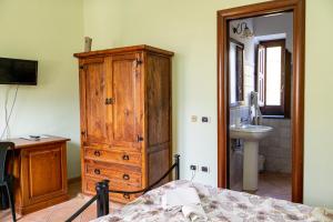 a bedroom with a large wooden cabinet and a sink at Agriturismo Casa Scola in Gragnano +193 photos