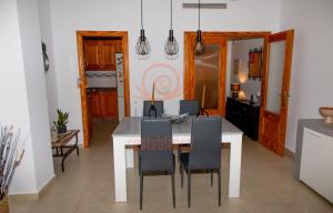 a kitchen and dining room with a table and chairs at APARTAMENTO ZEN. TEULADA. LIVE IT COSTABLANCA in Teulada