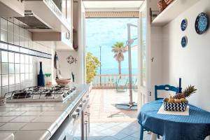 a kitchen with a table and a view of the ocean at Leuca lungomare by LoveSud in Leuca