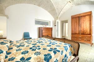 a bedroom with a bed and a dresser in a room at Leuca lungomare by LoveSud in Leuca