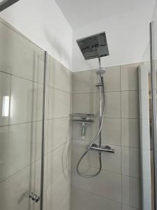 a shower with a shower head in a bathroom at Stadtgärtchen in Lüneburg +17 photos