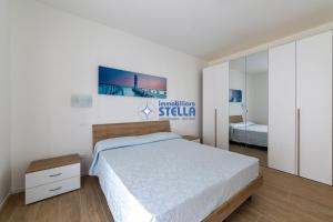 a bedroom with a bed and a mirror at Condominio Medusa in Lido di Jesolo