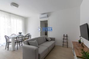a living room with a couch and a table at Condominio Medusa in Lido di Jesolo