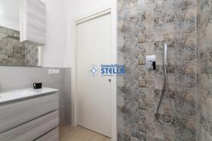 a bathroom with a shower and a sink at Condominio Medusa in Lido di Jesolo