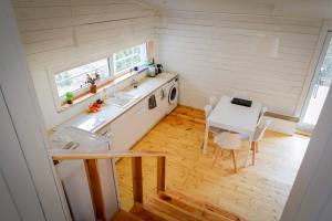 a small kitchen with a table and a sink at Dom Granero w Lesie pod Ślężą in Będkowice